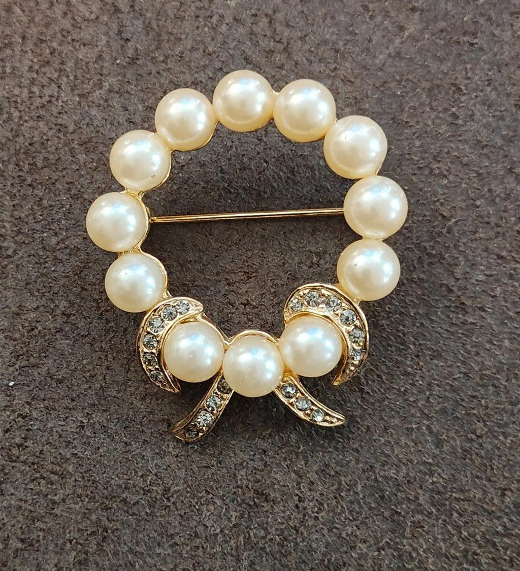 Gold-tone faux pearl wreath bow brooch with clear rhinestone trim and gold pin bar