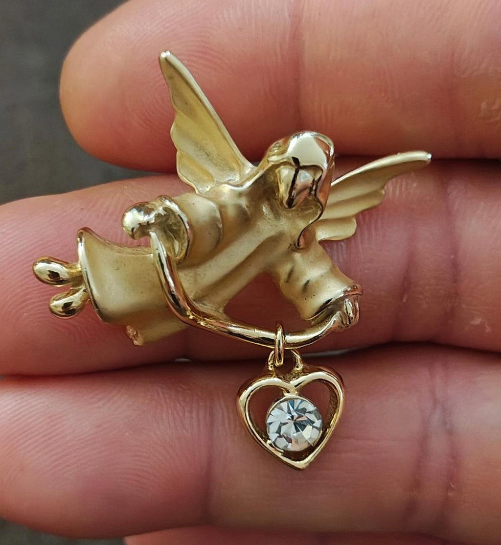 Gold-tone angel brooch pin with heart dangle charm and clear faceted crystal stone