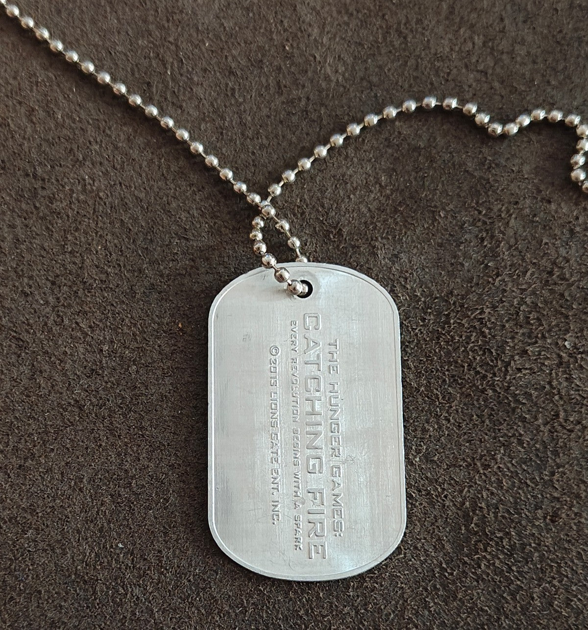 Promotional "The Hunger Games: Catching Fire" District 12 Victor Dog Tag