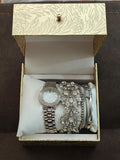 Silver-tone women’s stackable accessory watch set in open gift box with multiple bracelets