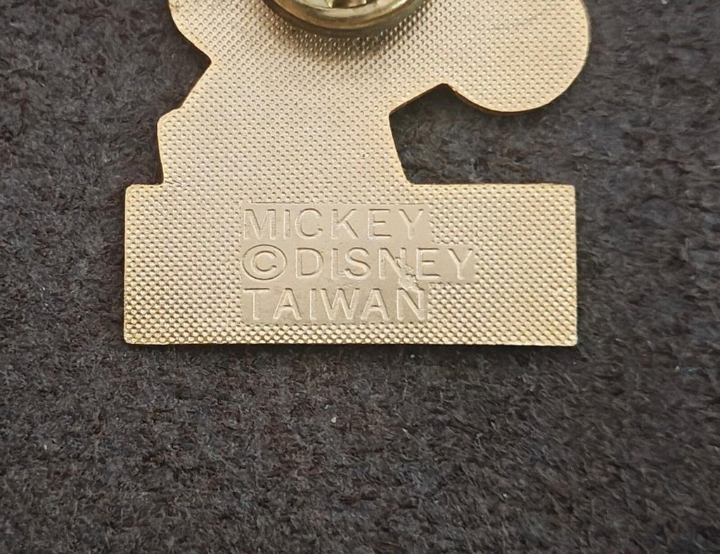 Gold-tone pin back close-up with stamped text: MICKEY, DISNEY, TAIWAN