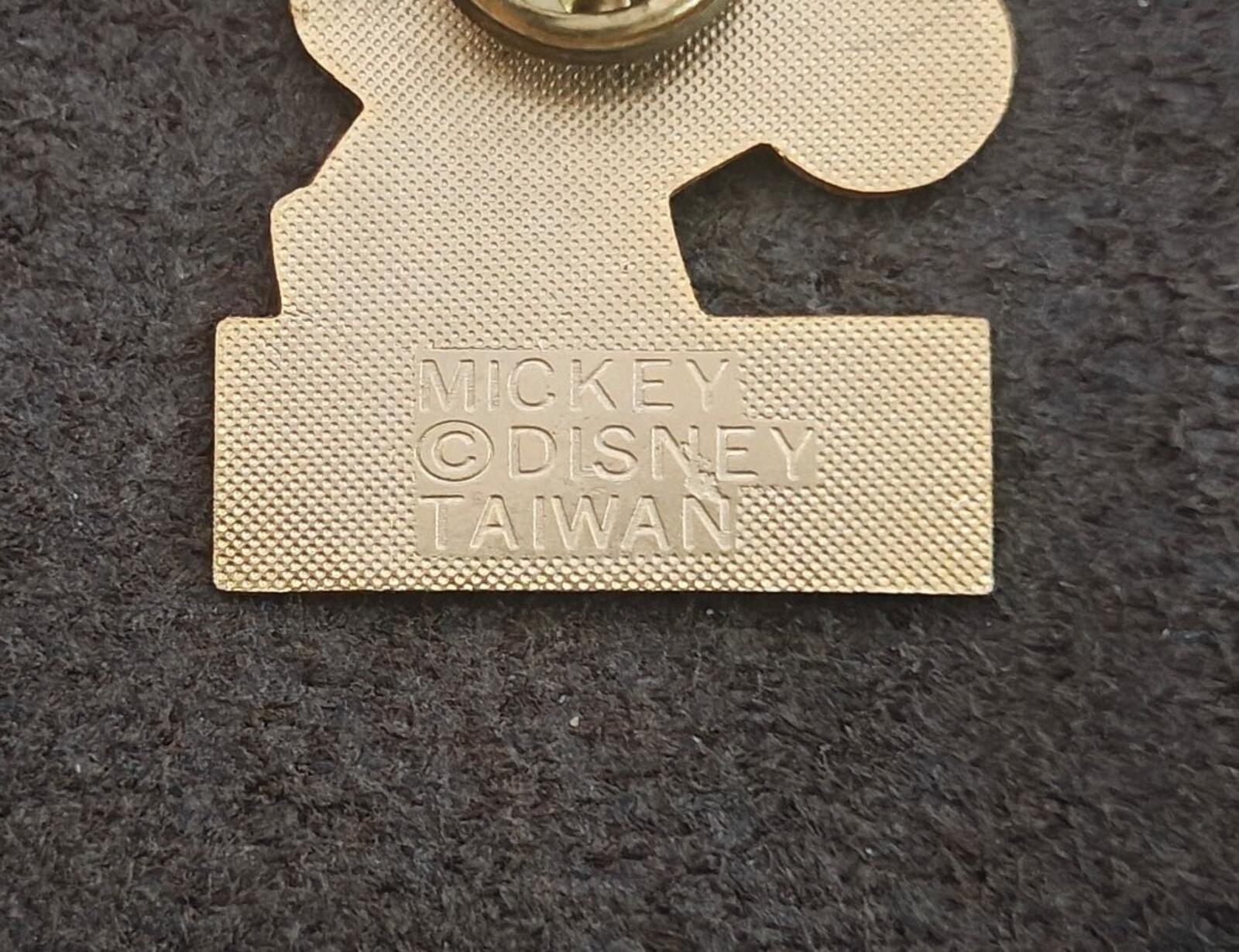 Gold-tone pin back close-up with stamped text: MICKEY, DISNEY, TAIWAN