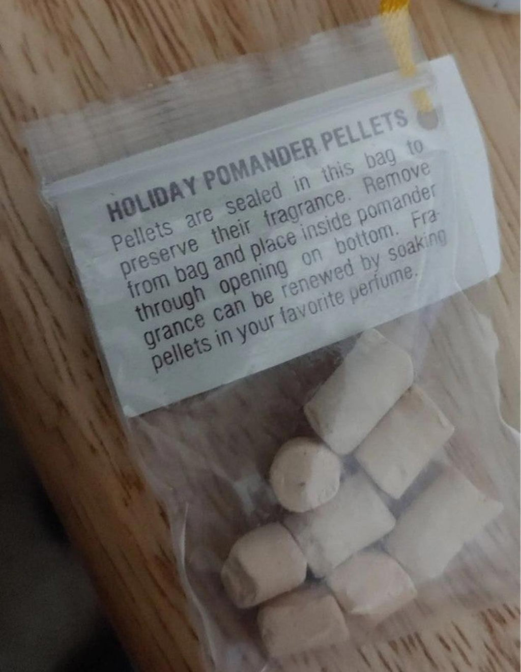 Holiday pomander pellet info card with white pellets in sealed pouch