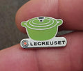 Le Creuset green mini cocotte enamel pin with silver-tone base and logo