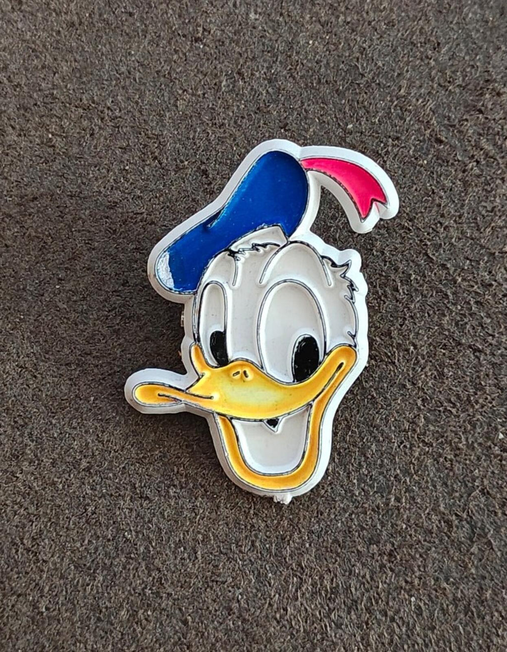 Vintage Donald Duck plastic pin, front figure with blue cap, white face, yellow beak