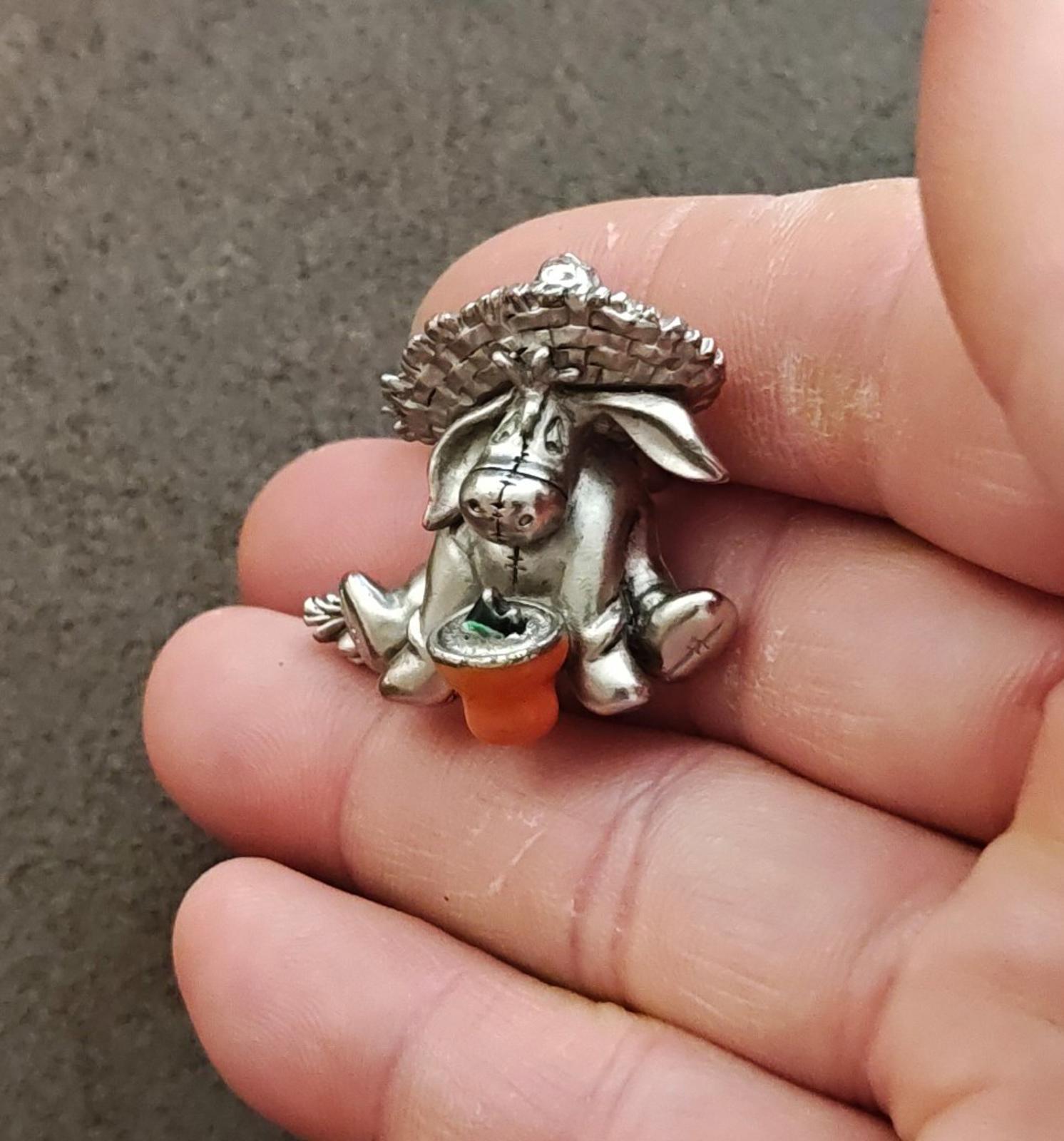 Eeyore pewter enamel pin close-up with orange base and green enamel bowl