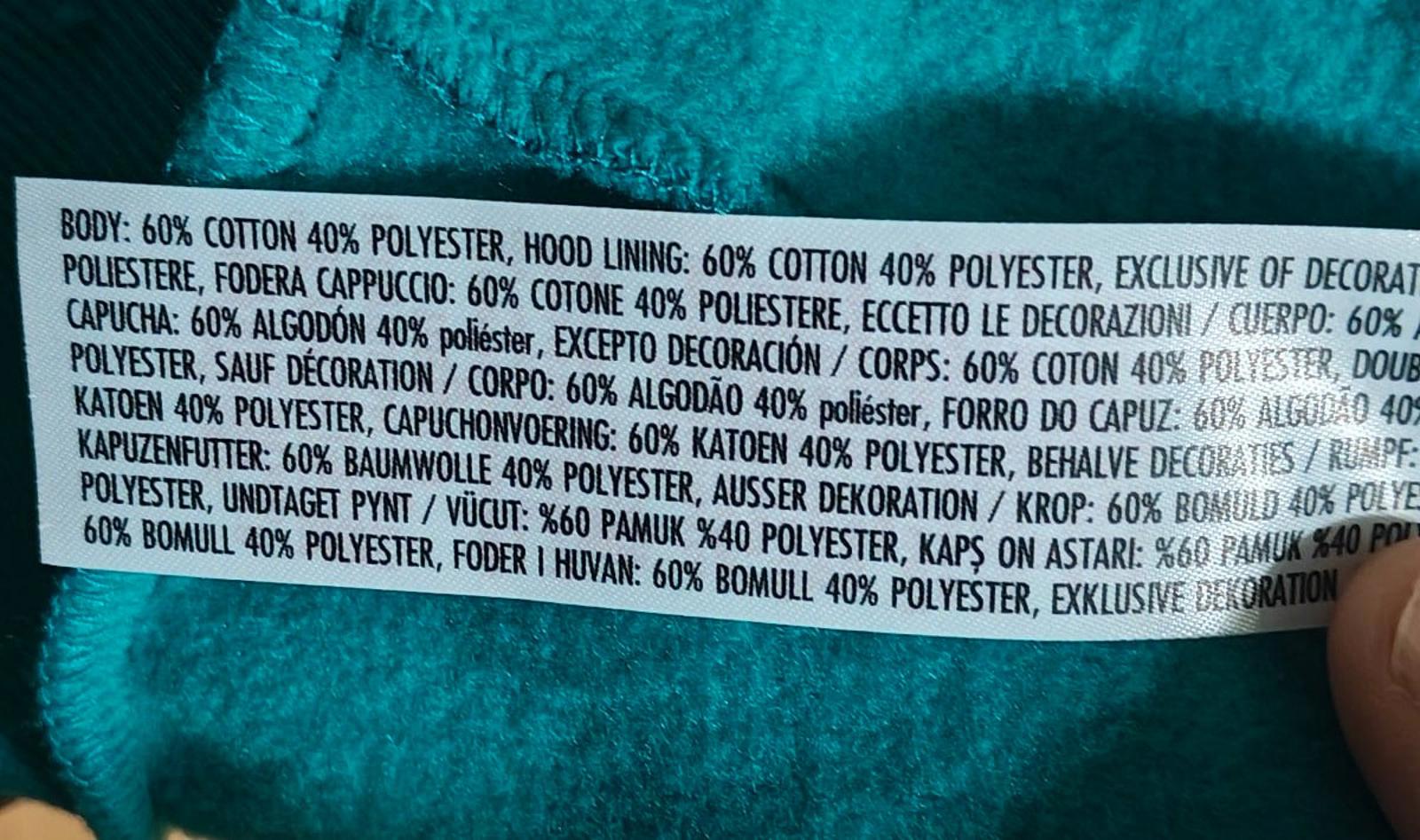 Teal hoodie fabric content label with cotton and polyester blend details