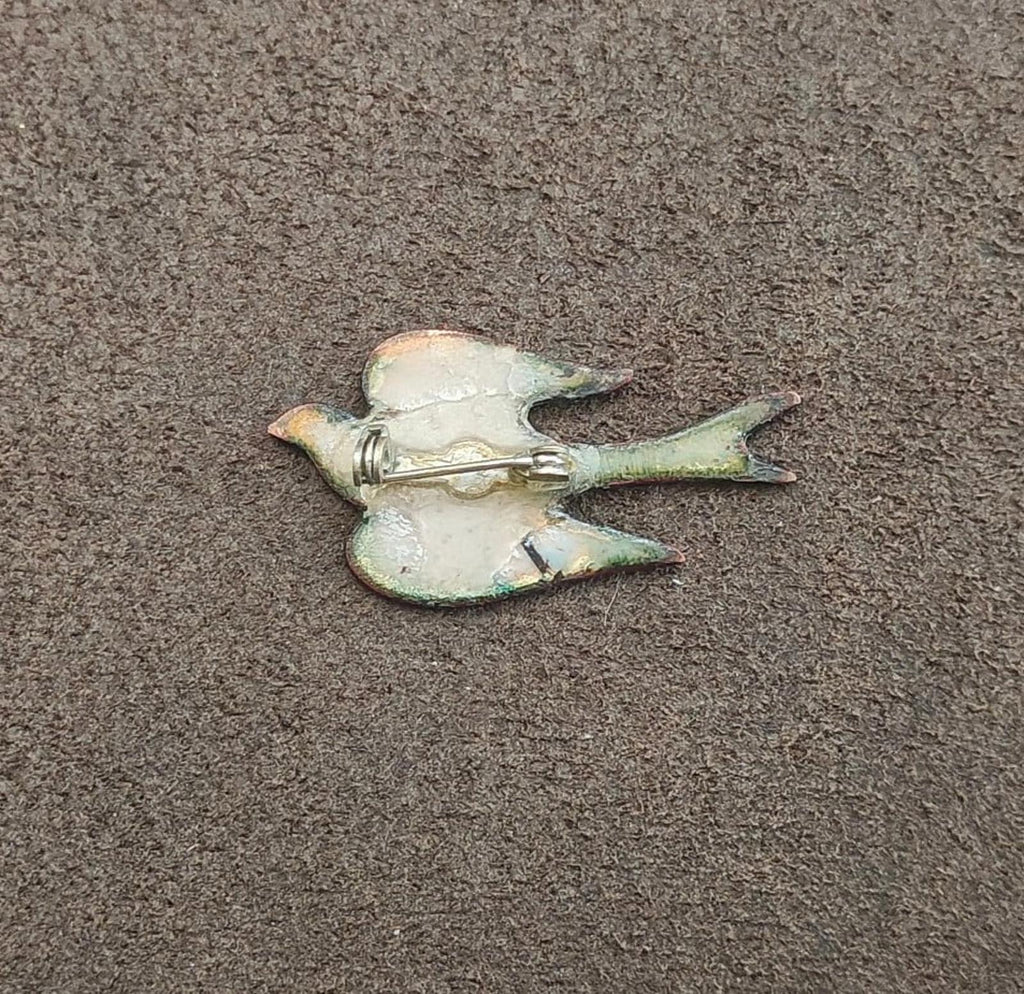 Bird brooch reverse side with metal pin and clasp, worn enamel backing