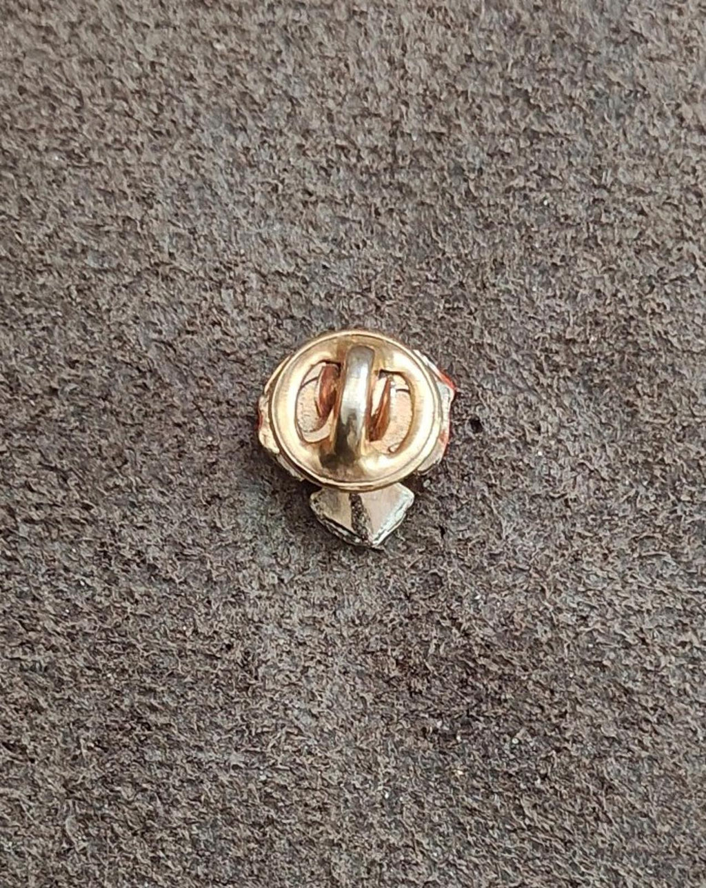 Gold-tone pin clasp back of a small enamel pansy brooch