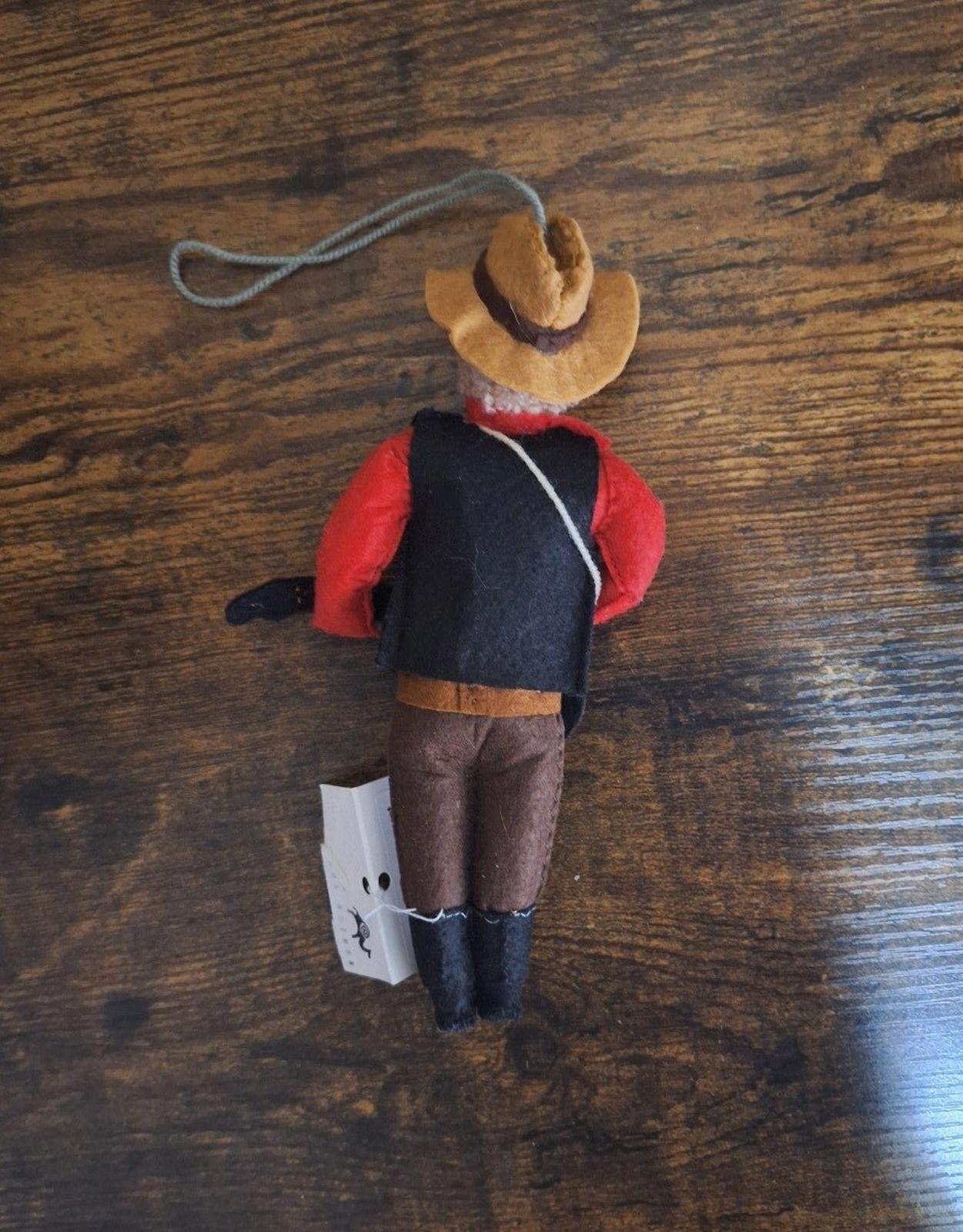 Felt and wool musician ornament back view with red sleeves, hat, and hanging loop