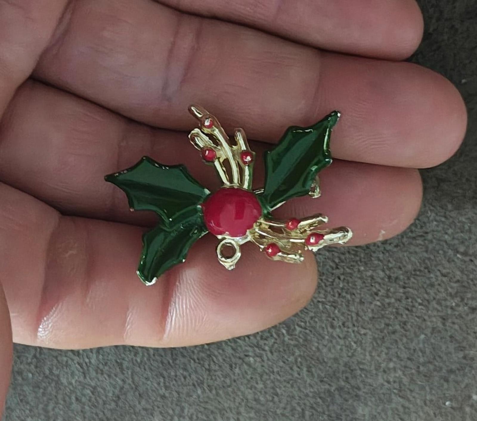 Green holly enamel brooch pin with red berry centerpiece and gold-tone top detailing