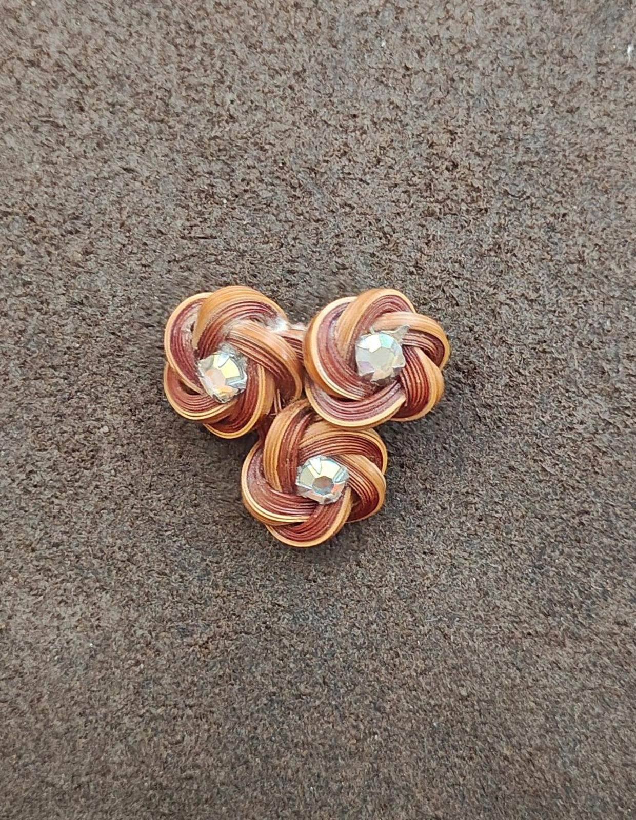 Three-flower bamboo rosette brooch with rhinestone centers and brown coil petals