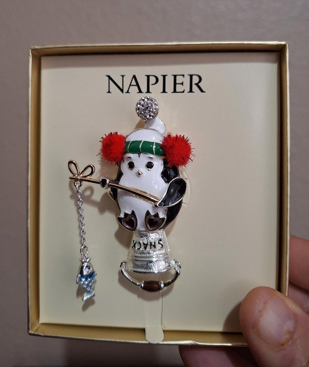 Napier silver-tone enamel penguin fishing pin in gift box, close-up view