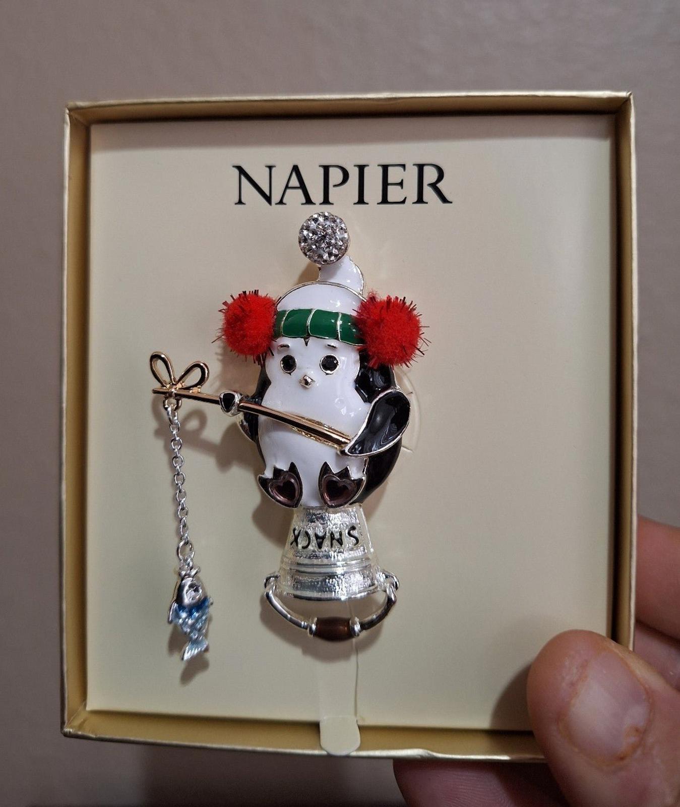 Napier silver-tone enamel penguin fishing pin in gift box, close-up view