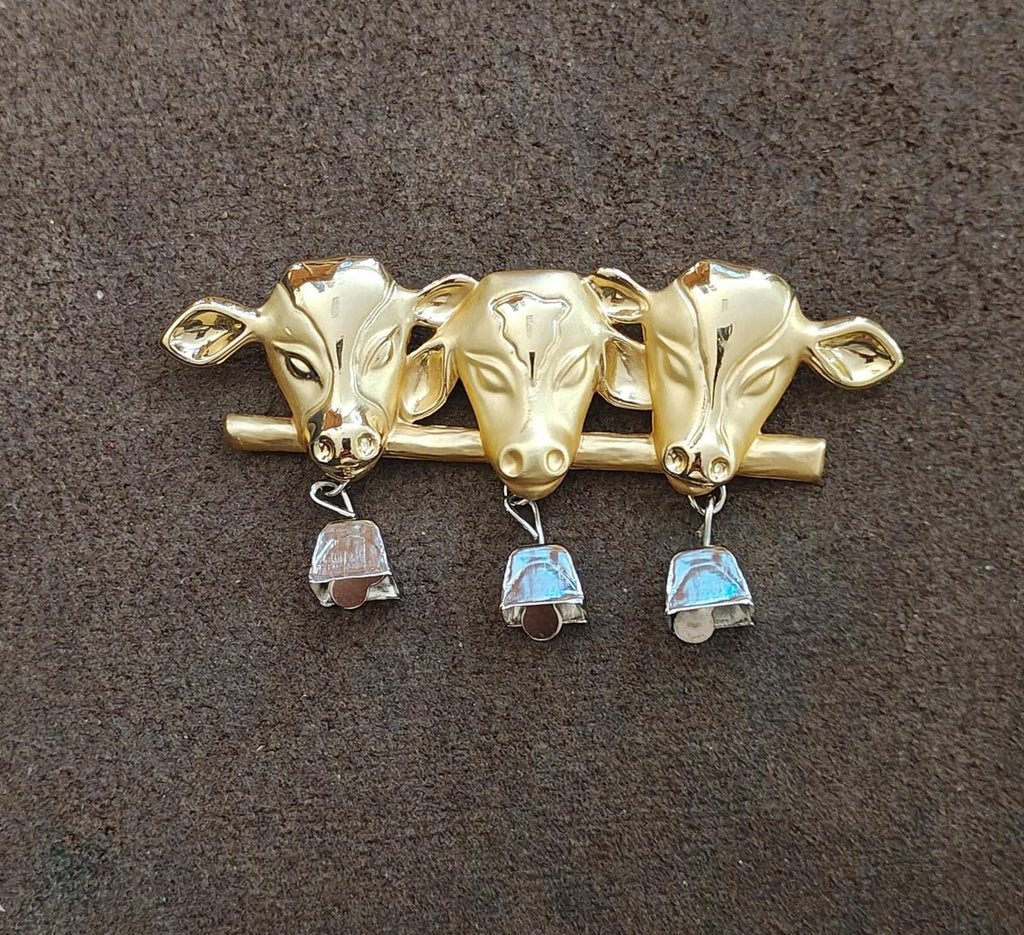 Gold-tone cow head brooch with three silver bells and blue enamel details