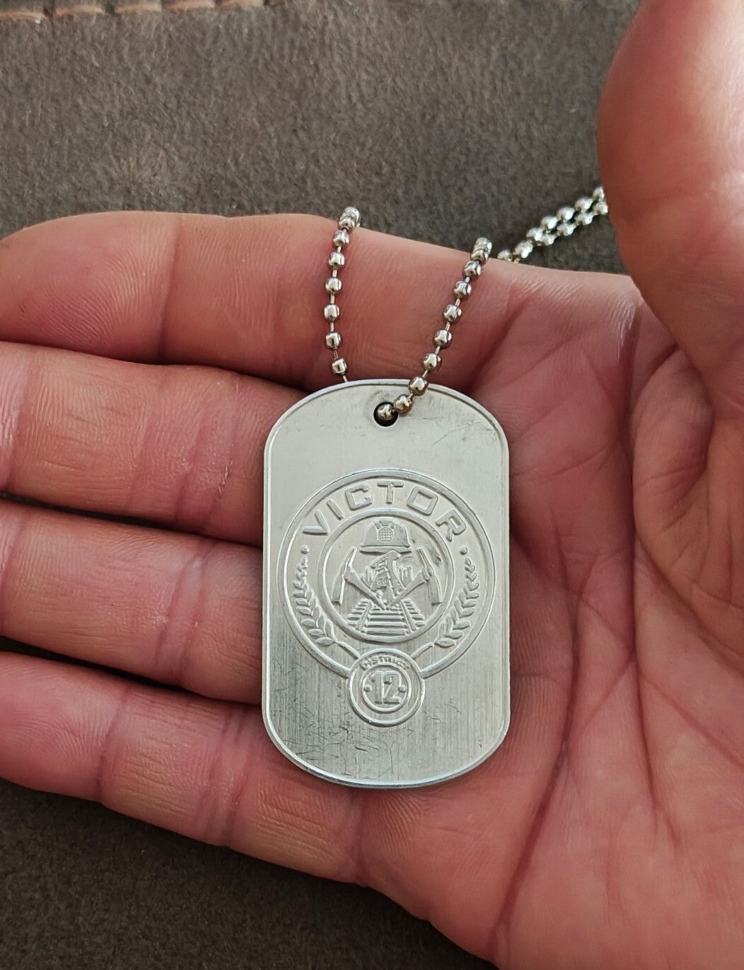 Promotional "The Hunger Games: Catching Fire" District 12 Victor Dog Tag