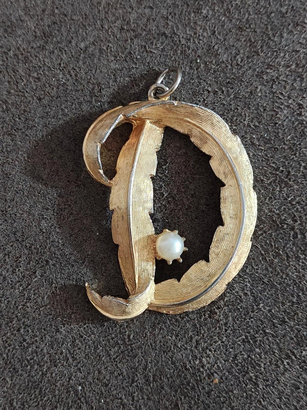 Gold-tone D monogram pendant with white pearl drop and silver-tone hanging bail