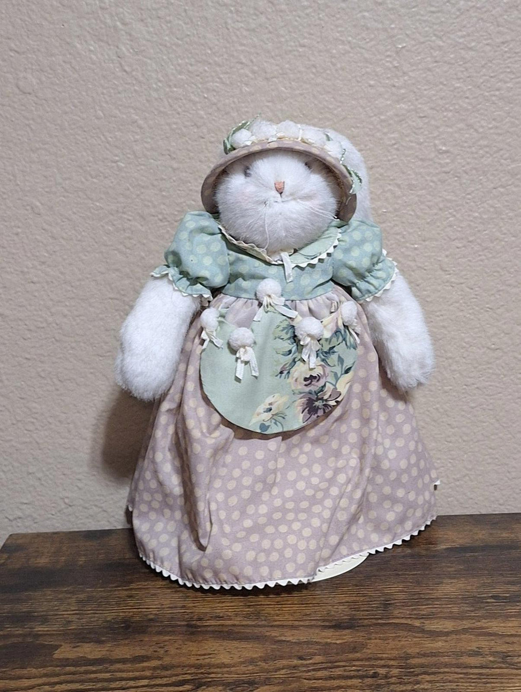 Plush bunny doll standing, wearing pastel bonnet and lilac polka-dot dress with pocket