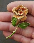 Gold-tone enamel rose and leaf pin, orange petals and green leaves with raised details