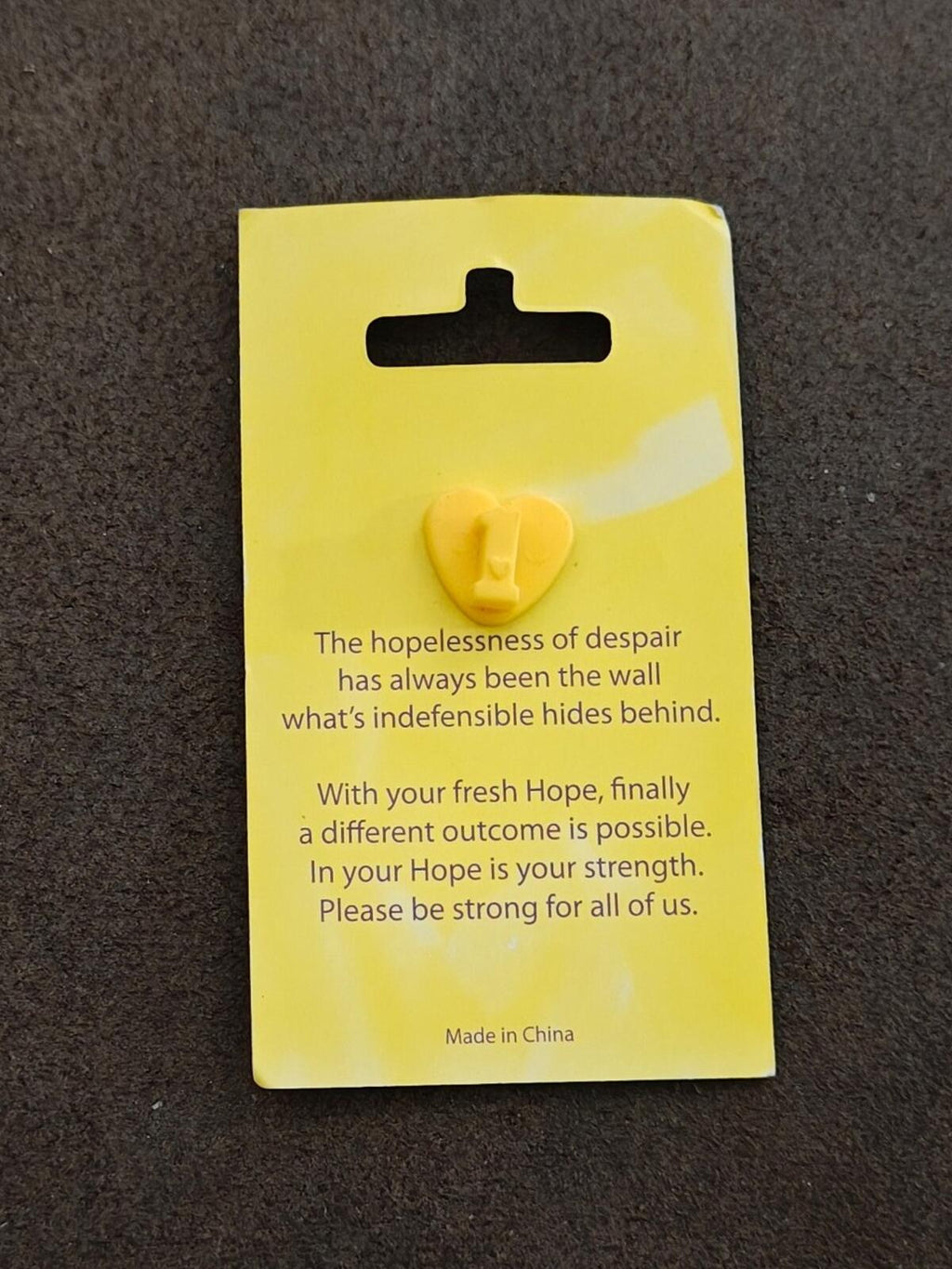 Rainbow heart enamel pin back on yellow card with hope quote and heart pin post