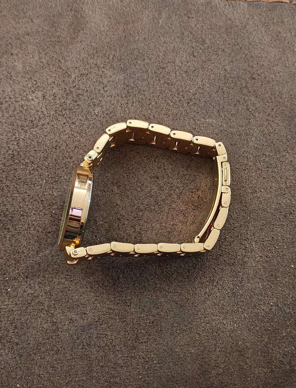Gold watch bracelet with clasp and polished metal links