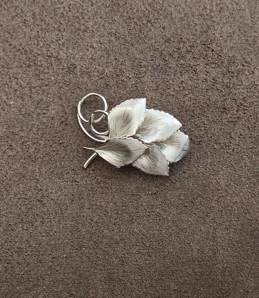 Silver leaf cluster brooch with ring loop clasp and slender pin