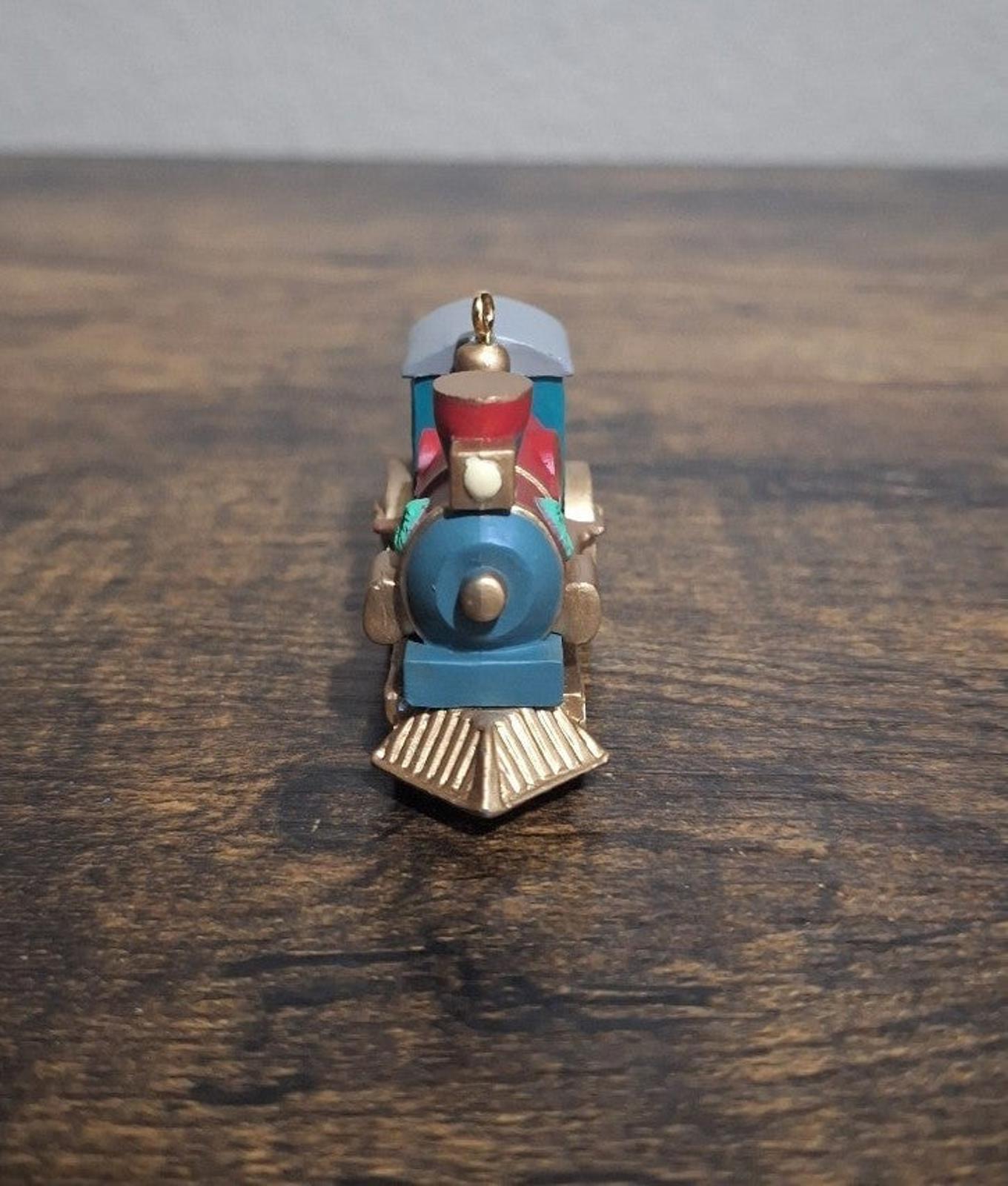 Blue train locomotive ornament, rear view with red top smokestack and hanging loop