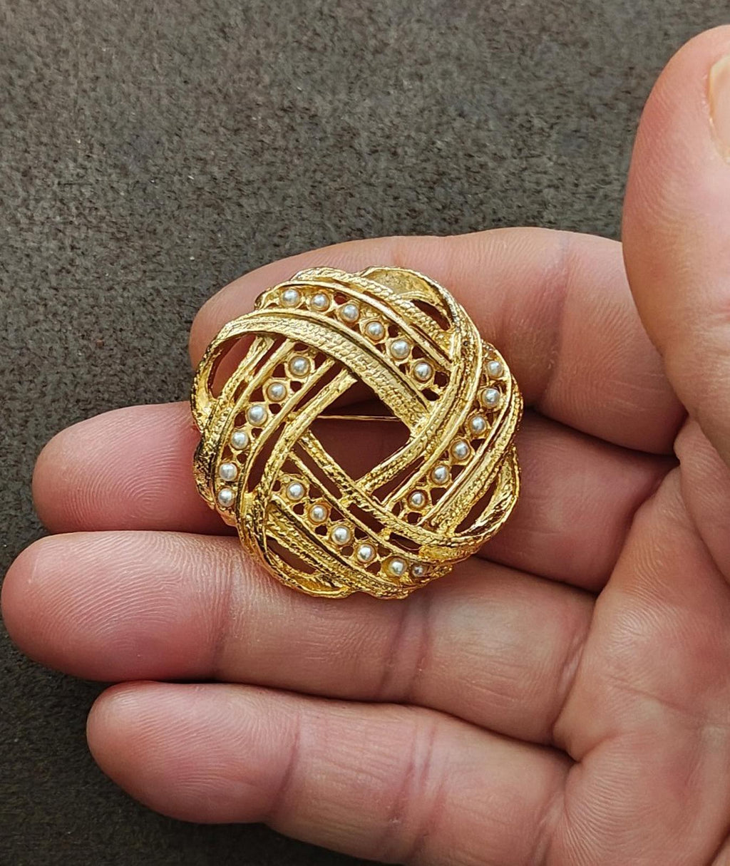 Gold-tone Victorian brooch with faux pearls, braided trim, and openwork center