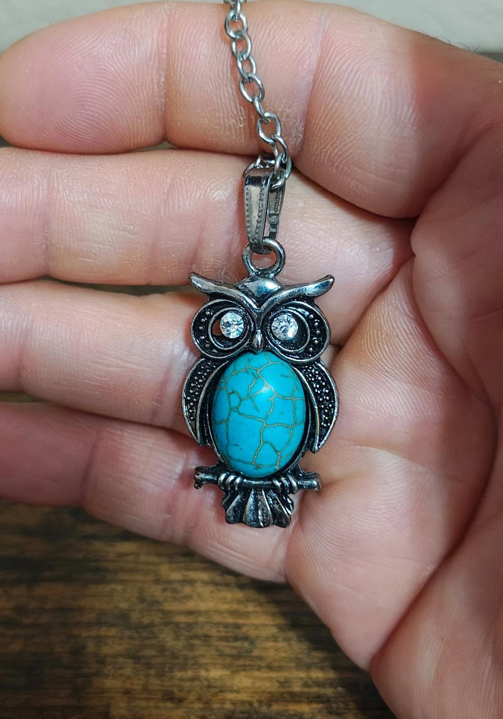 Silver-tone owl pendant necklace featuring a blue turquoise owl face with crystal eyes