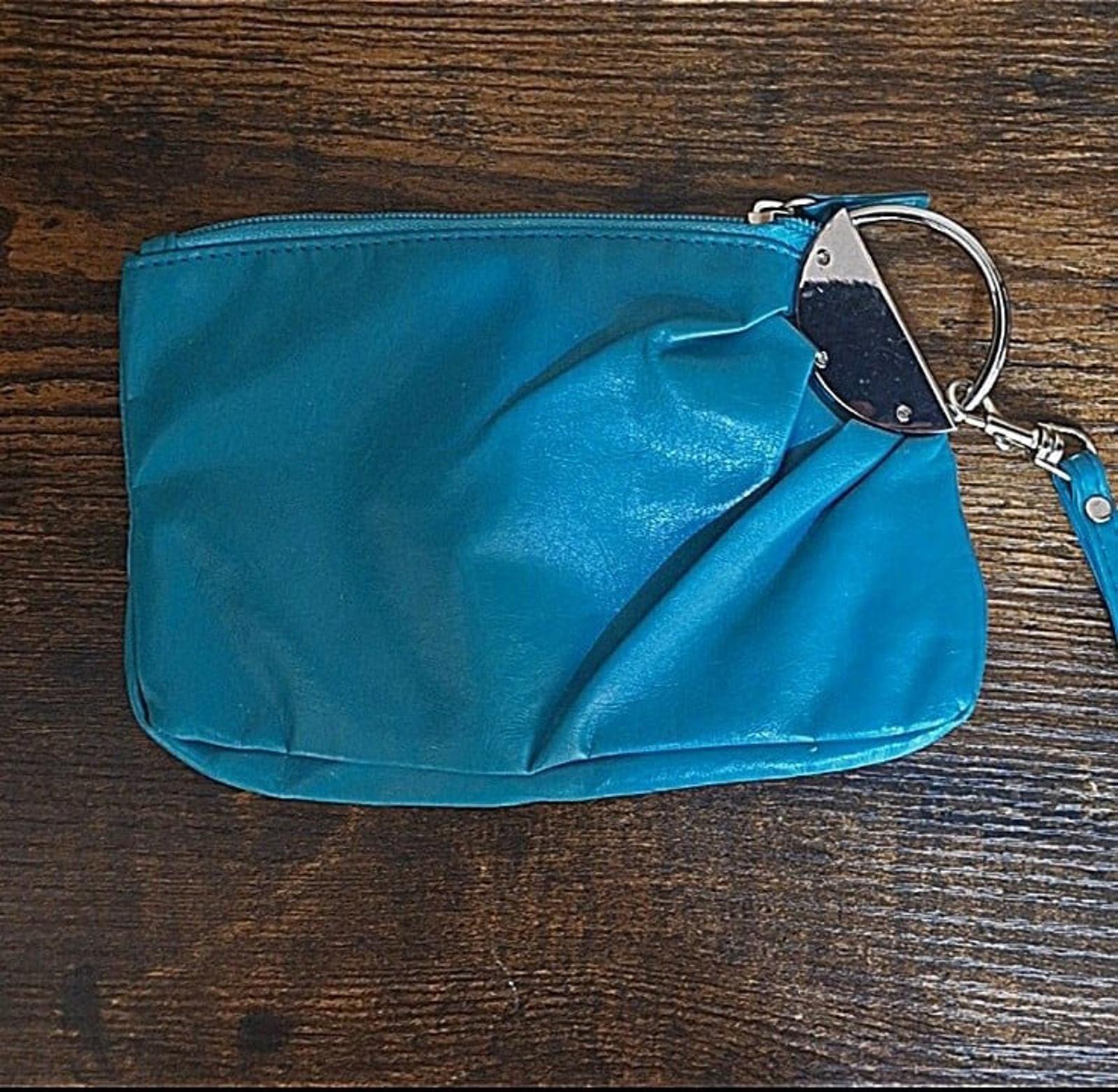 Teal PVC clutch purse with zipper closure and wrist strap, front view