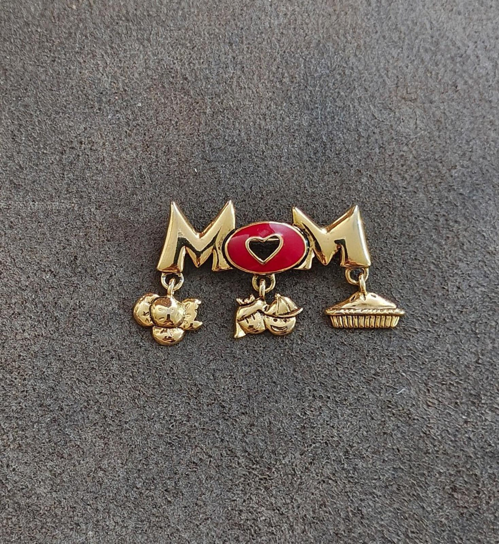 Gold-tone MOM brooch pin with red heart enamel center and charm dangles on bar
