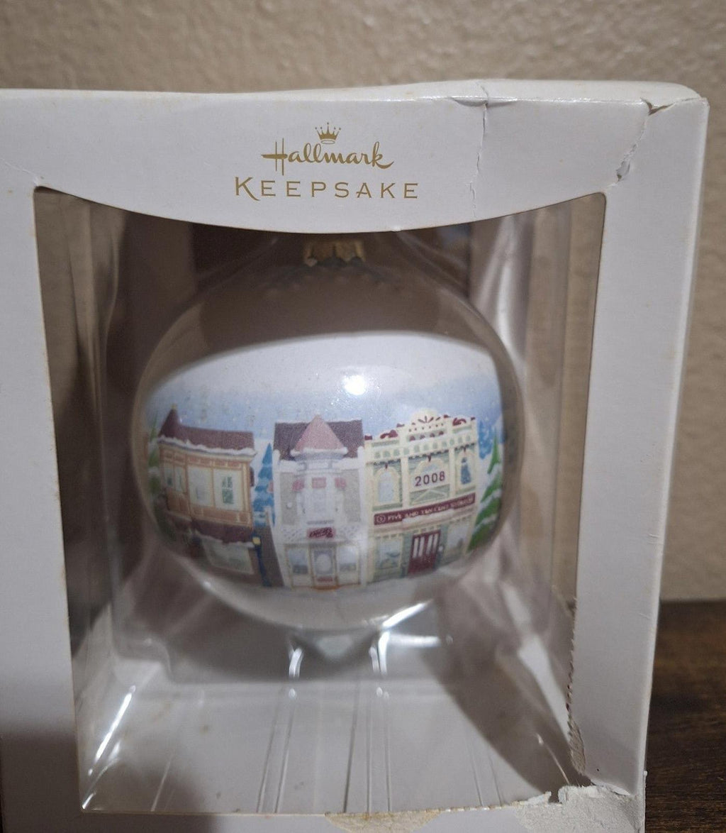 Hallmark Keepsake teardrop ornament close view with Main Street storefronts and 2008 detail