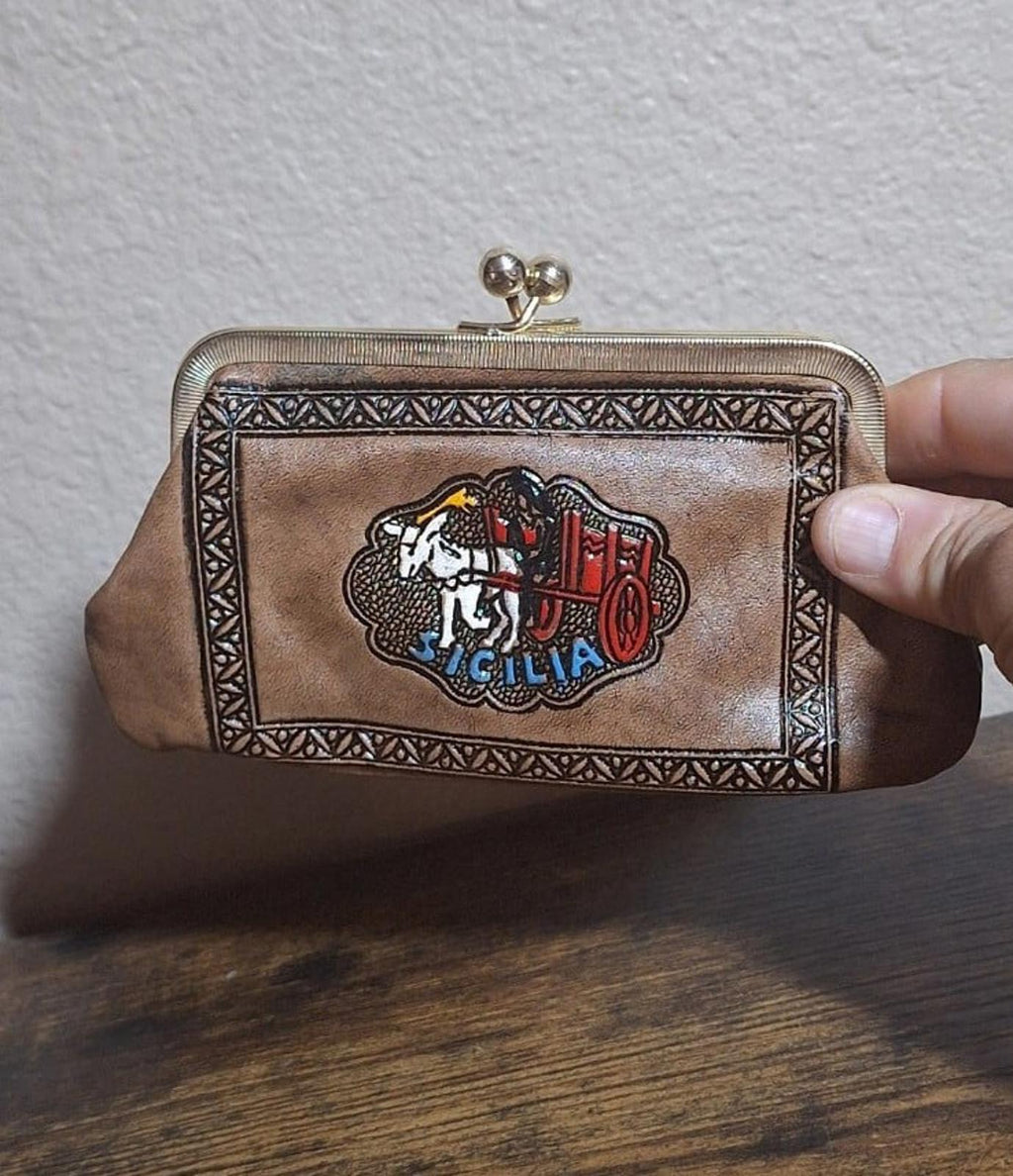 Tan leather coin purse wallet with clasp and embossed Sicily crest on the front.