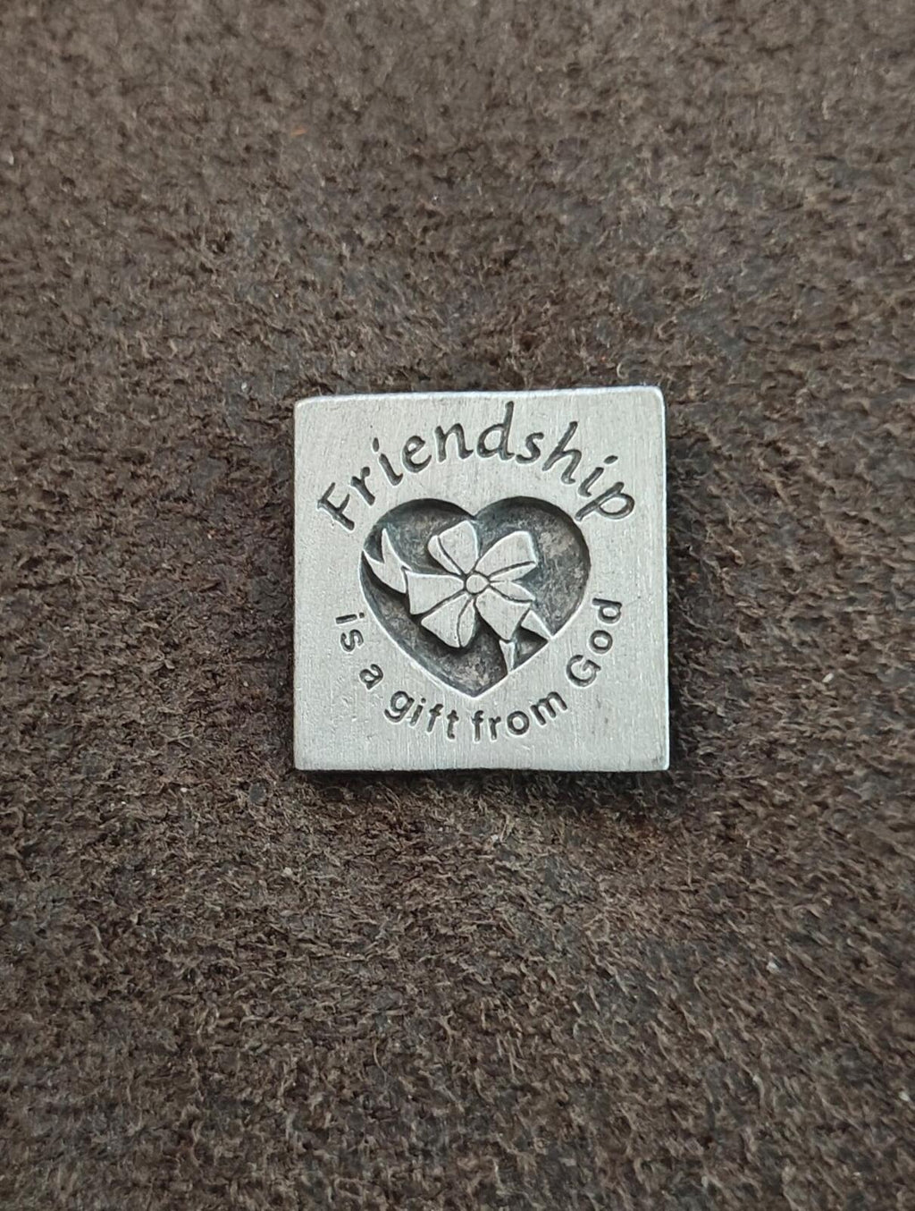 Silver square pin with engraved heart, flower, and friendship message
