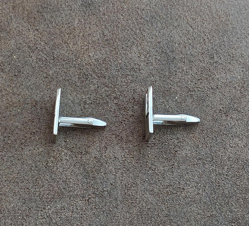 Silver-tone cufflink backs with bar posts and hinged mechanisms