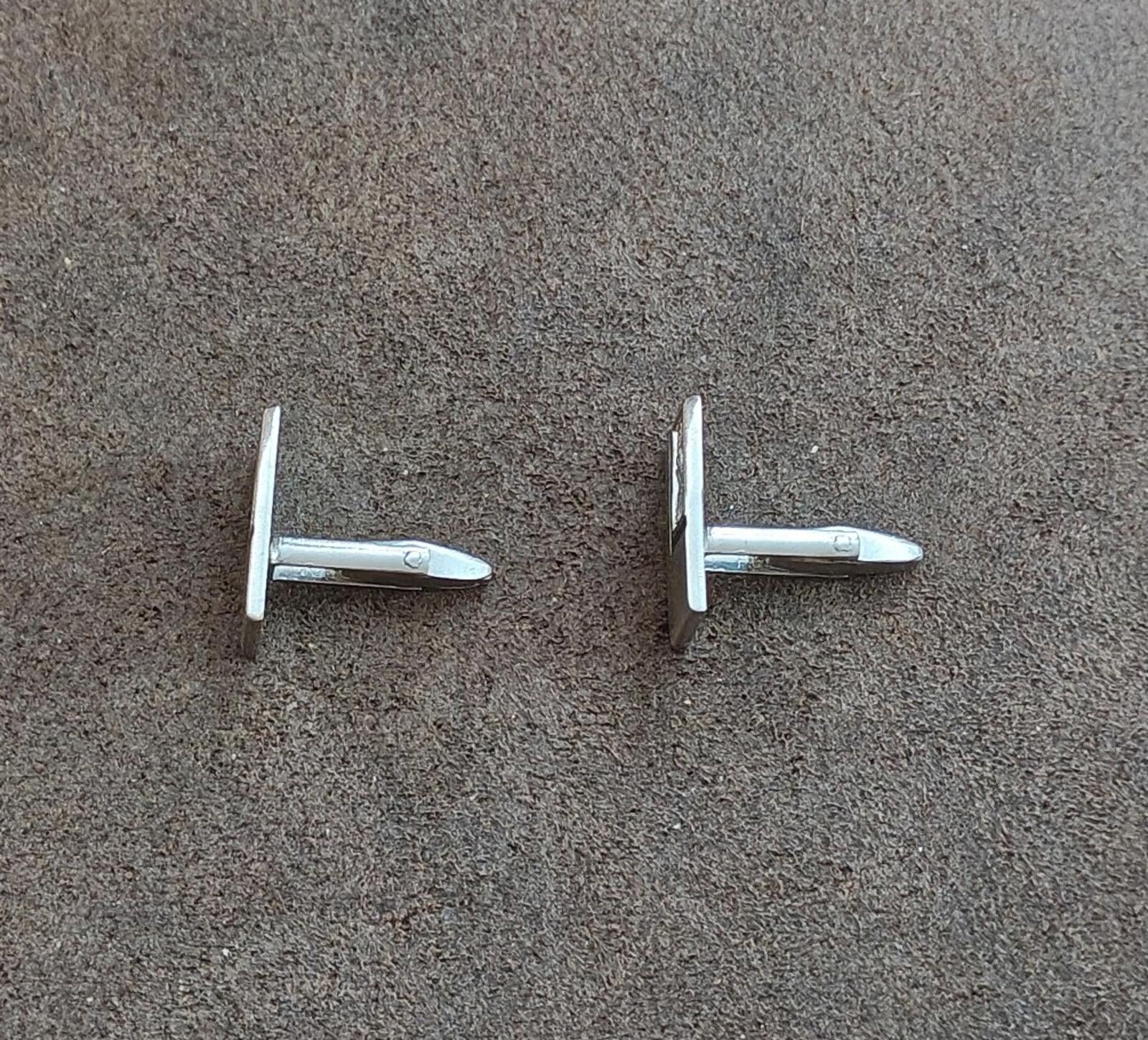 Silver-tone cufflink backs with bar posts and hinged mechanisms