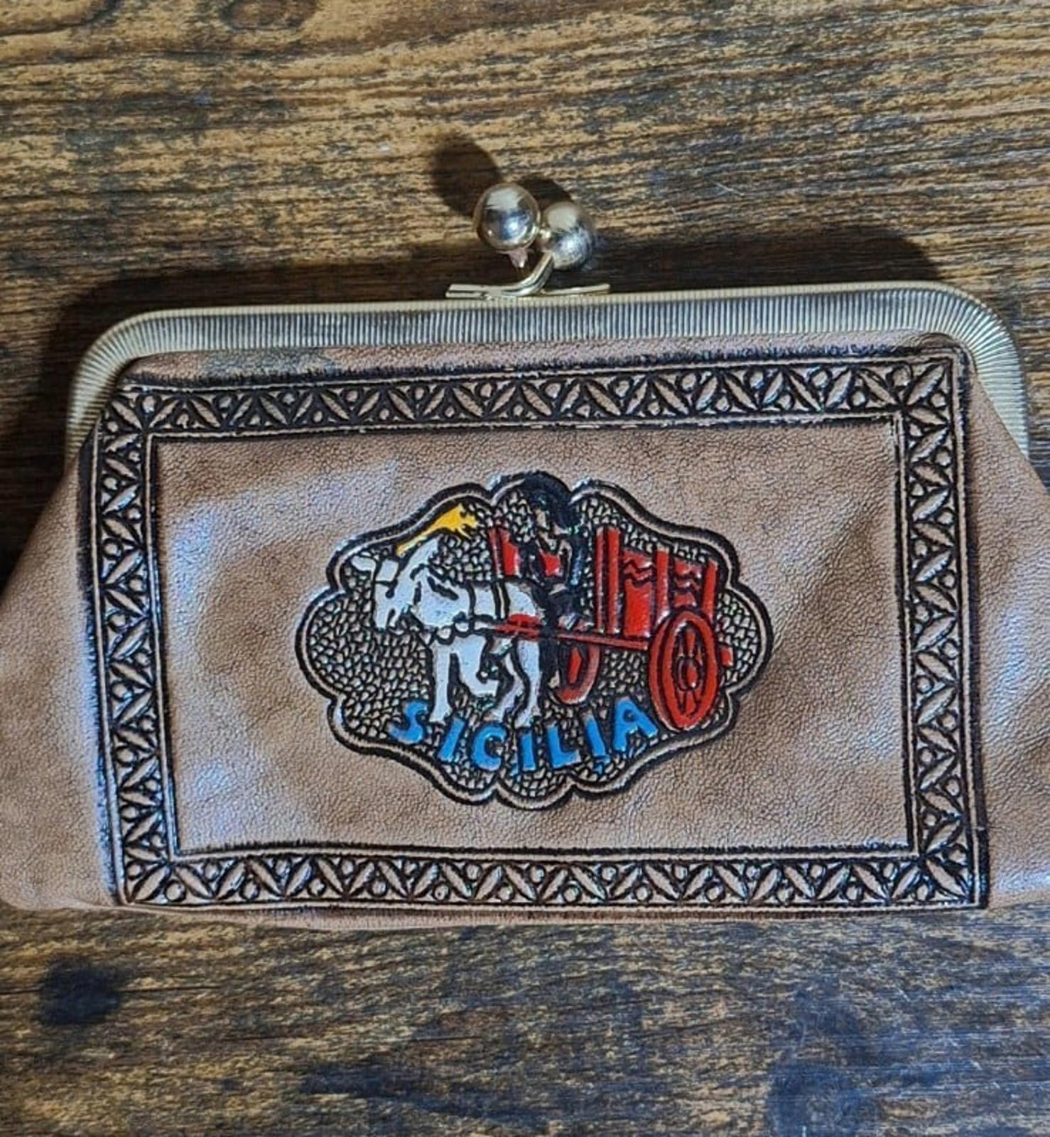 Tan leather coin purse wallet front with Sicily crest emblem and metal clasp frame.