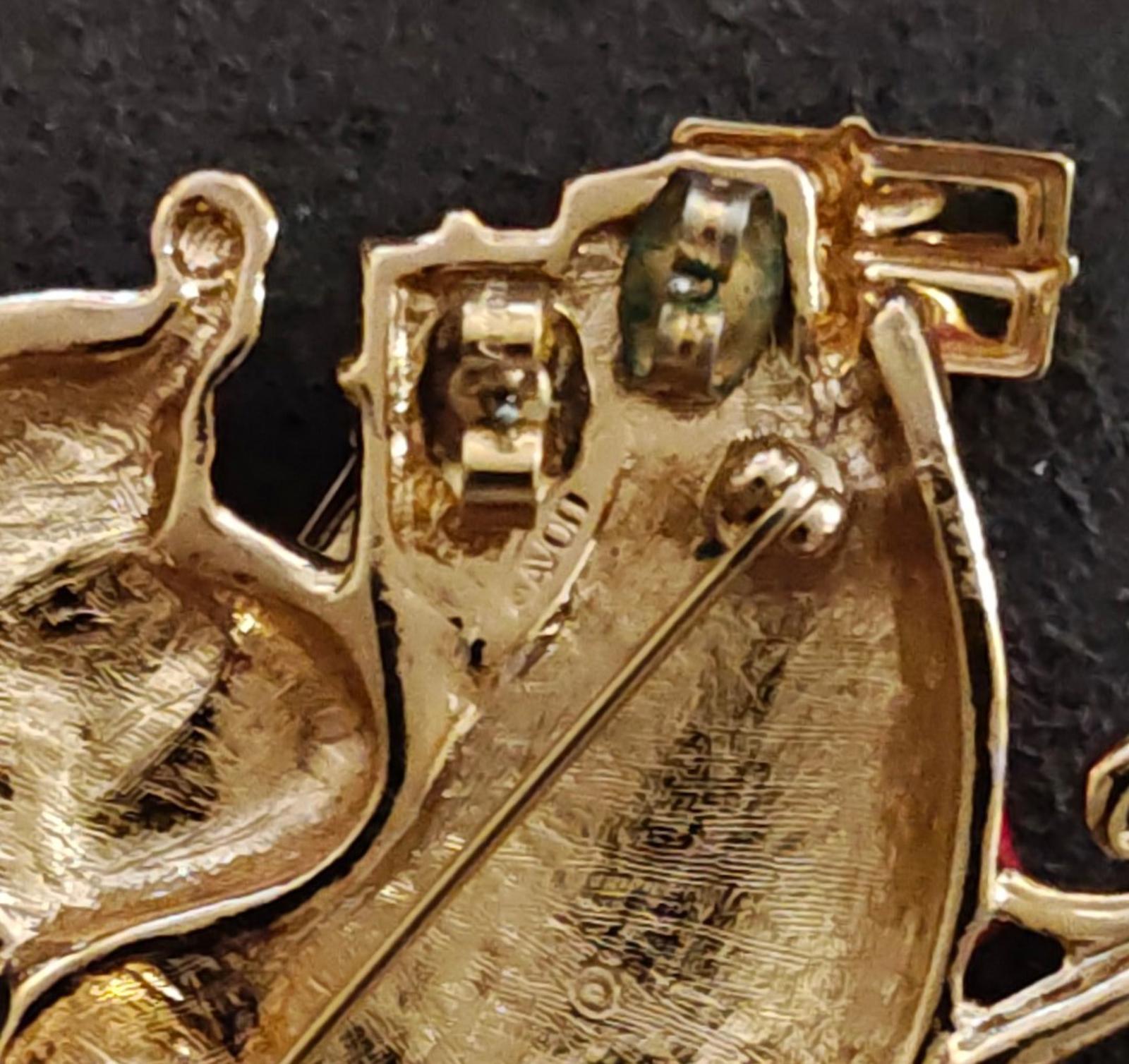 Gold-tone metal back and clasp hardware detail of Santa sleigh brooch