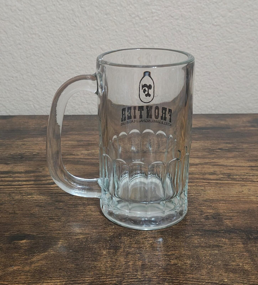 Clear glass beer mug with Frontier logo and hotel text on side