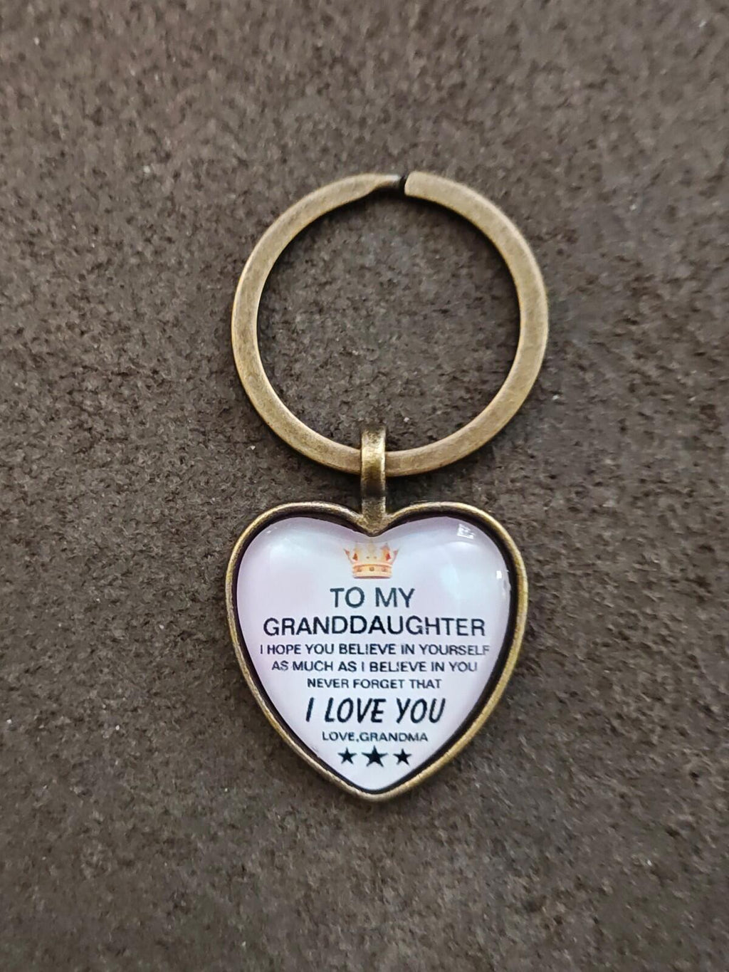 Brass-tone keychain with white heart pendant, “To My Granddaughter” text and “I Love You”