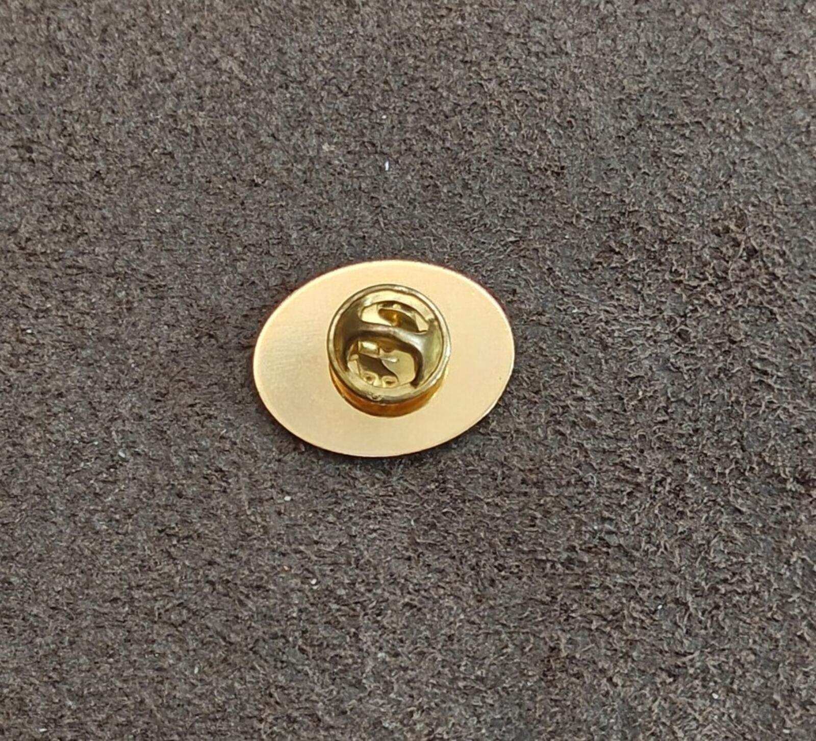 Round gold pin back with clasp and post