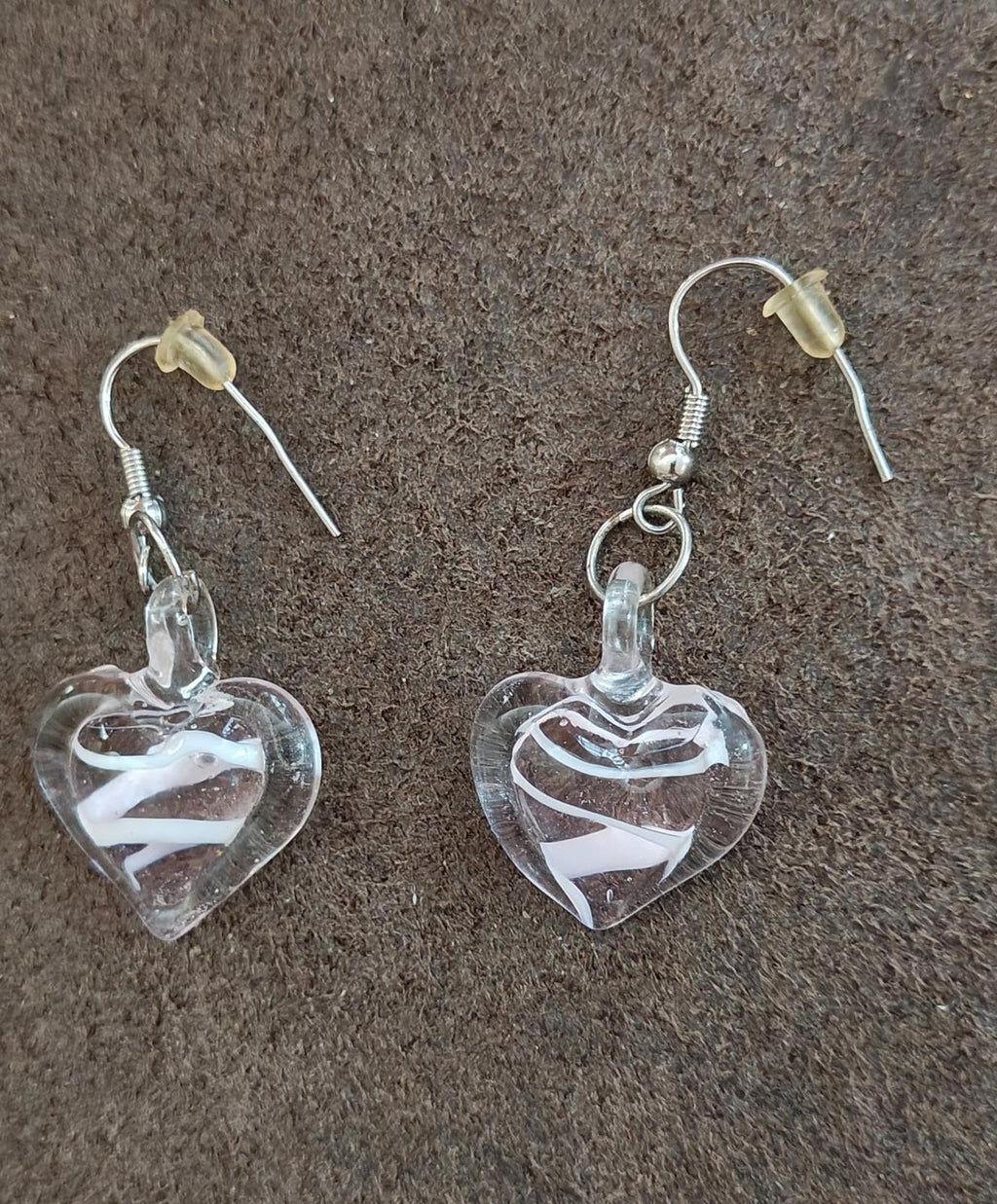 Heart-shaped glass drop earrings with swirling pattern and silver-tone hooks.