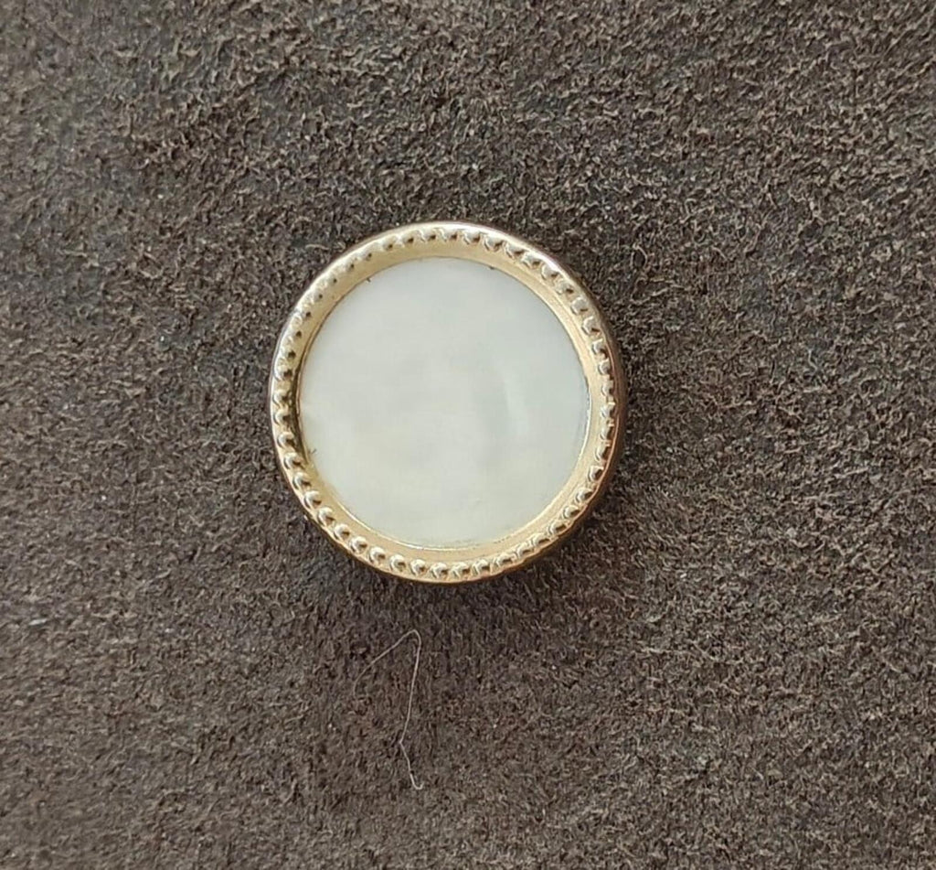 Gold-tone round mother-of-pearl brooch with raised beaded edge