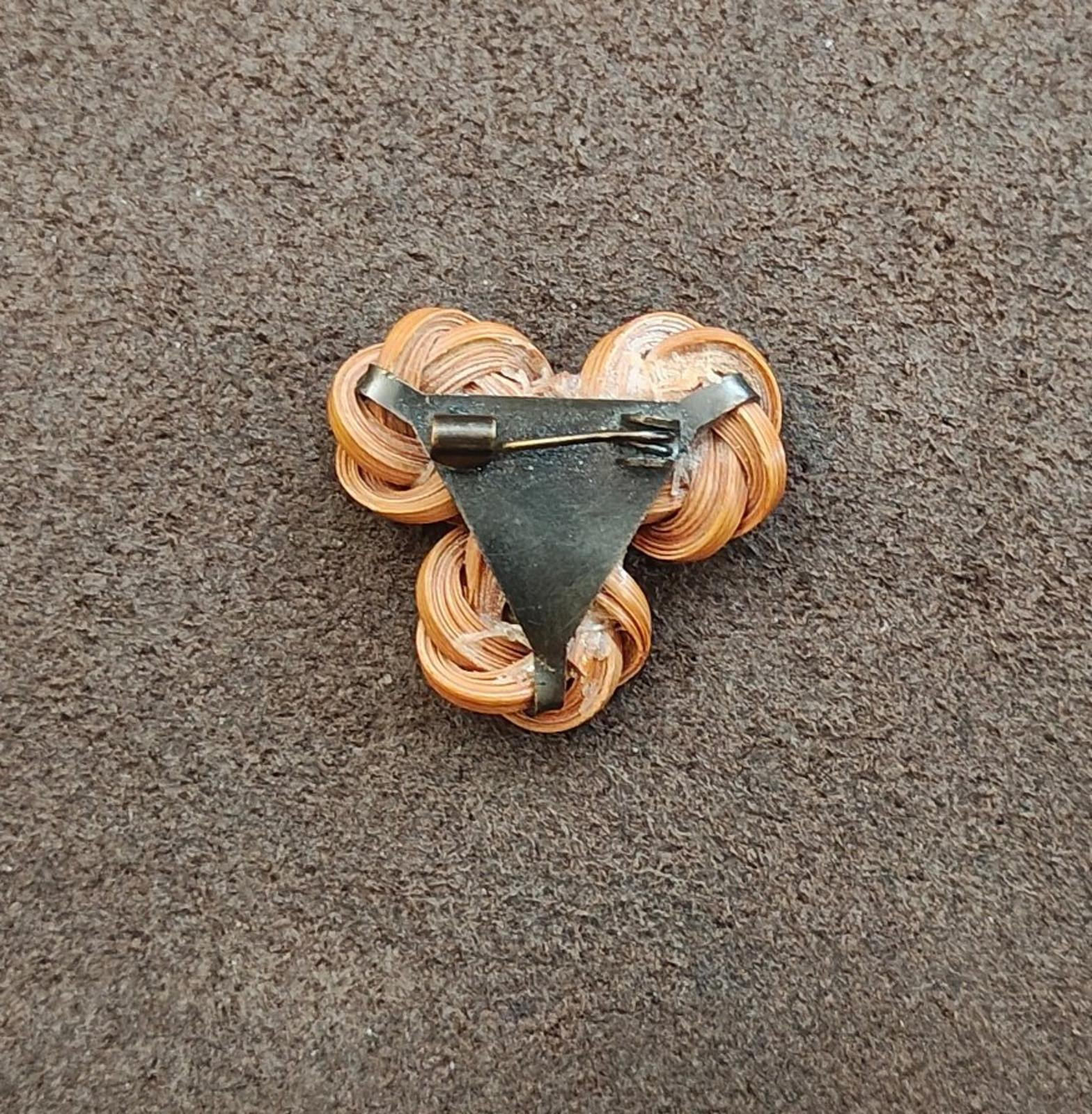 Back of three-flower bamboo rosette brooch pin with metal clasp and brown coilwork