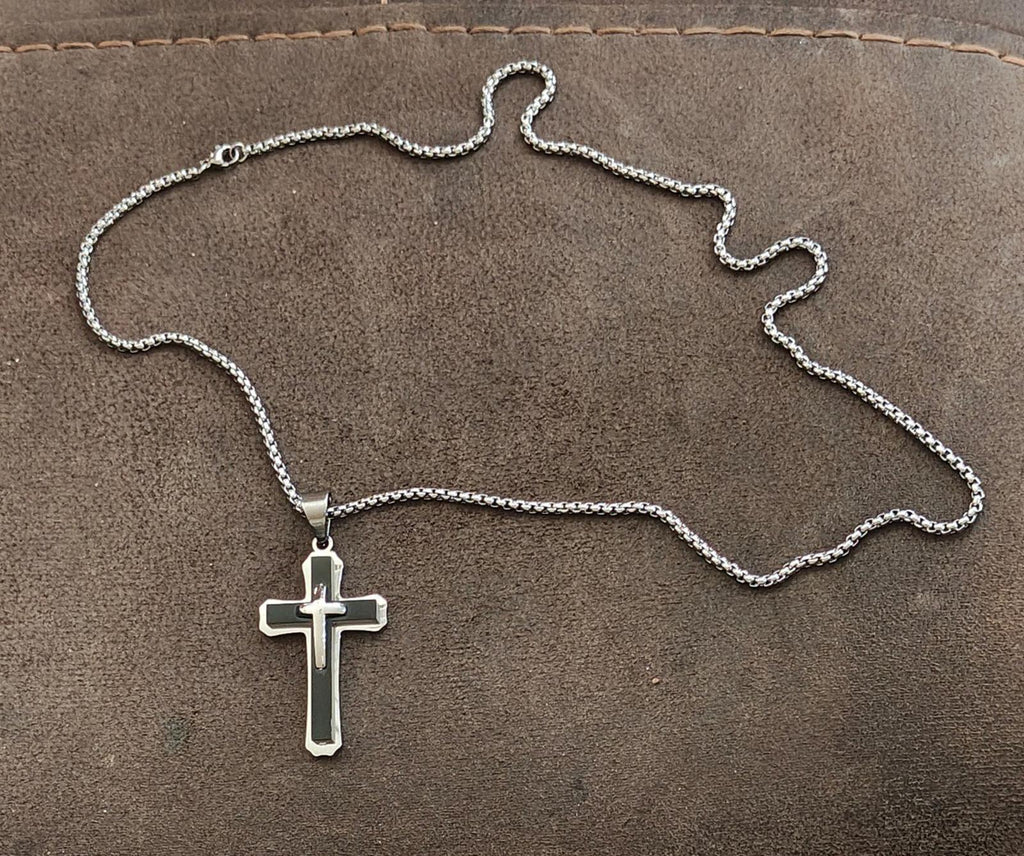 Silver-tone chain with small cross pendant necklace laid flat