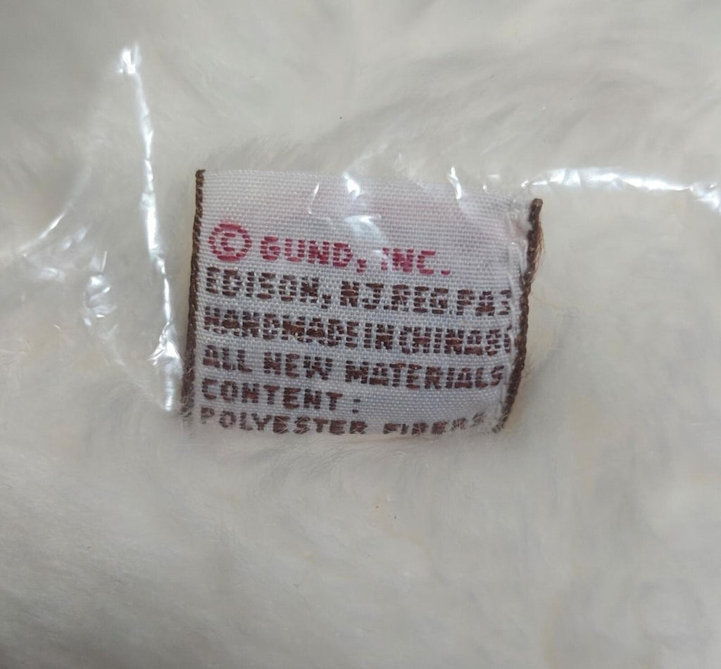 Fabric care label on plush bear, text on white polyester label