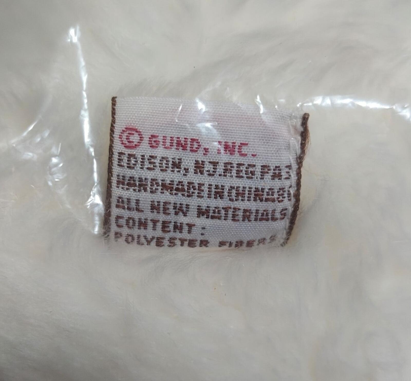 Fabric care label on plush bear, text on white polyester label