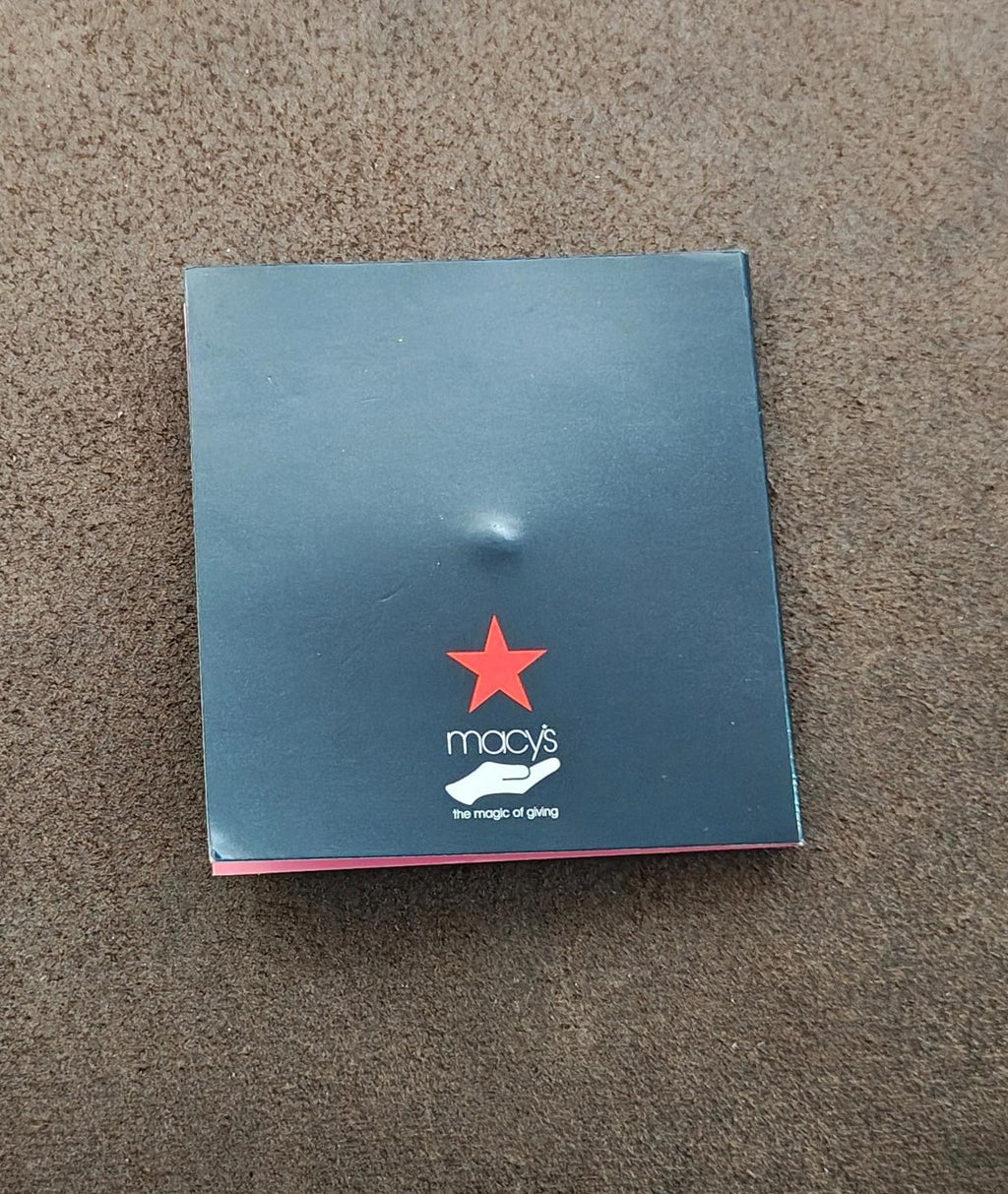 Macy’s gift box card with red star logo on light blue background