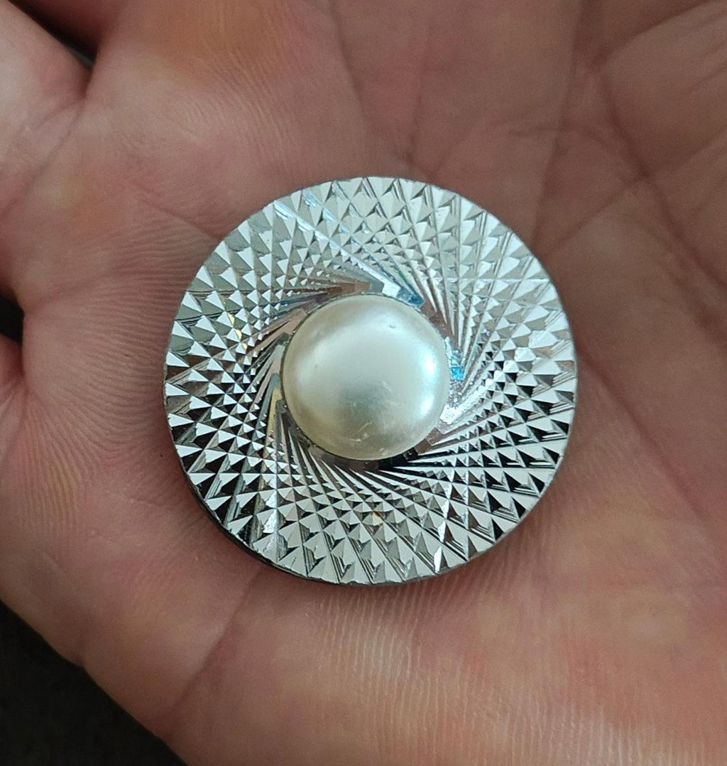 Round silver-tone scarf clip with diamond-cut texture and faux pearl center