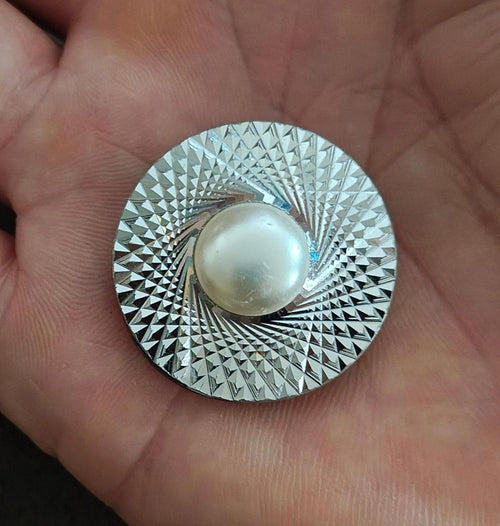 Round silver-tone scarf clip with diamond-cut texture and faux pearl center